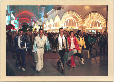 The heist gang in “3000 Miles to Graceland,” make their way through the crowded streets in front of the large casinos in Las Vegas, Nevada.